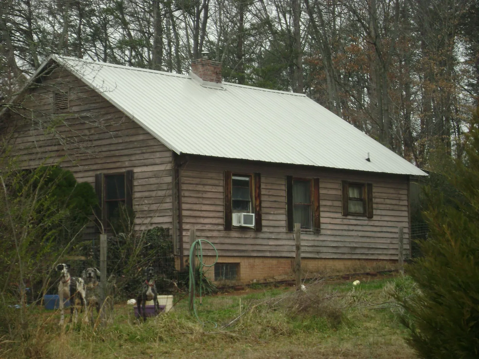 White metal roof on an old wood sided farmhouse, from a Metal Roof Installation job in Brookhaven